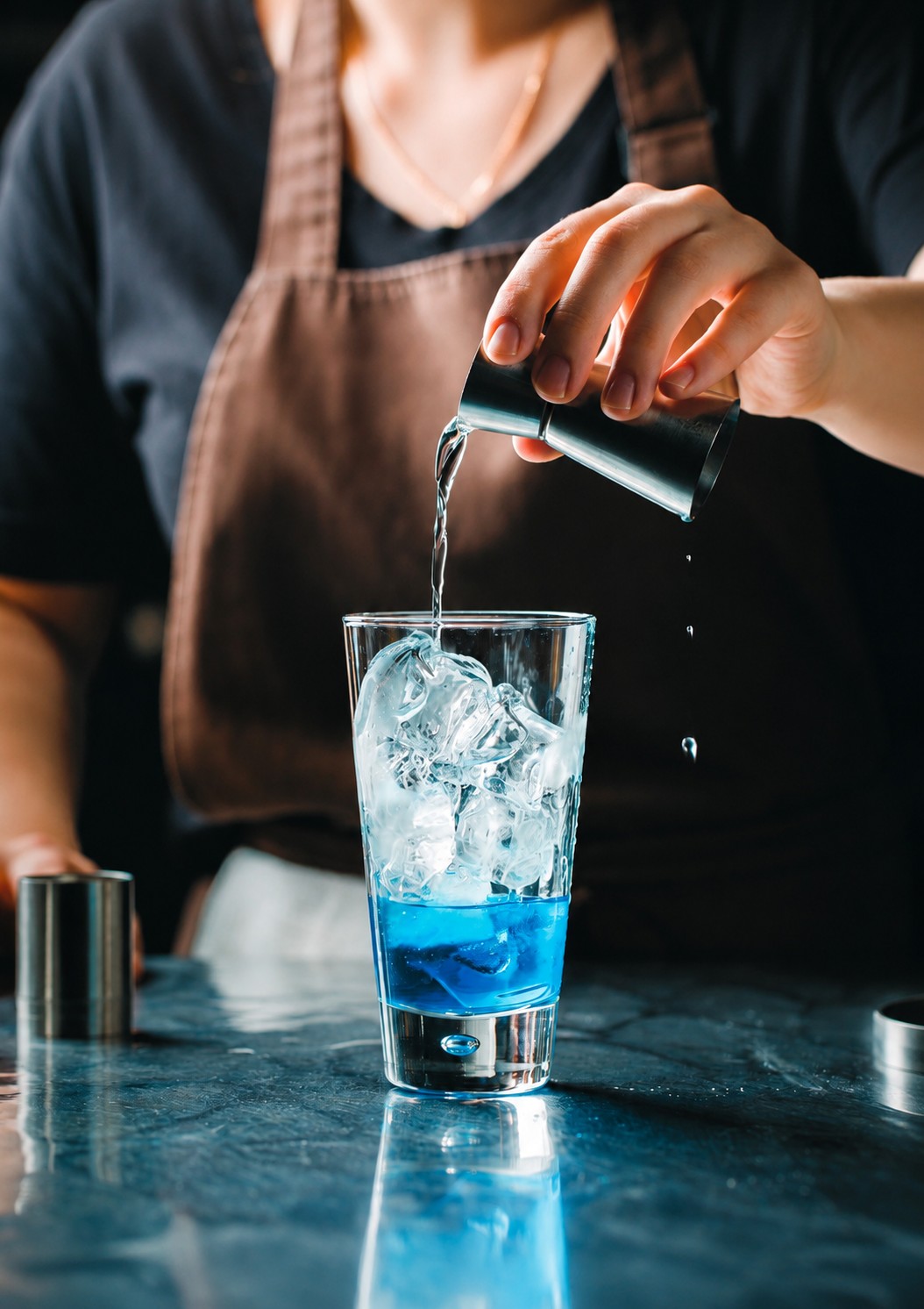 Bartender pouring over Aqua Frost ice